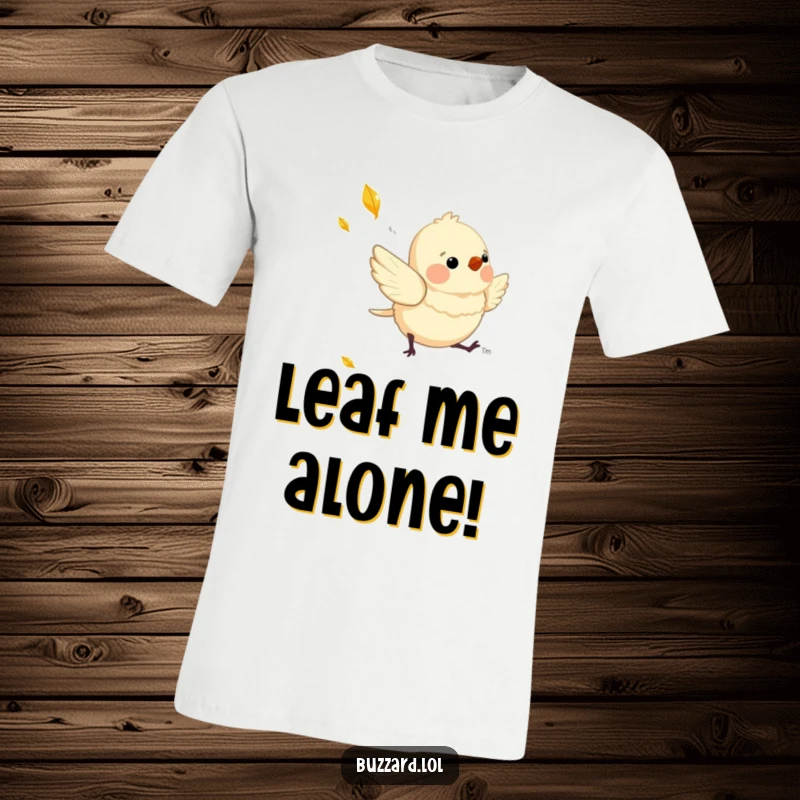 Funny T-Shirt showing a charming, downy bird playfully chasing a shimmering, falling leaf, full of zest.