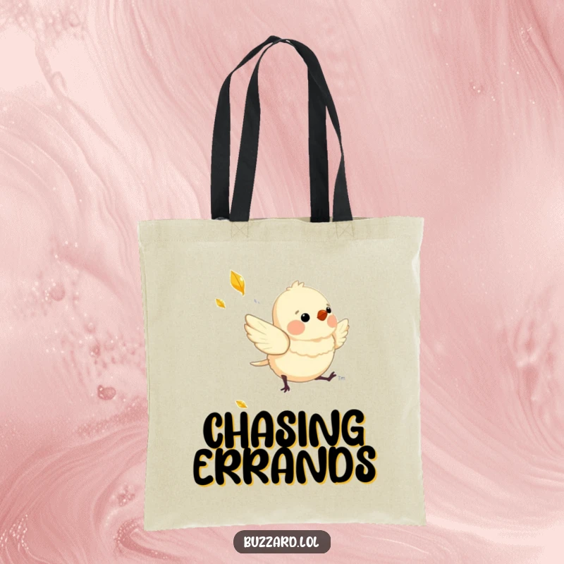 Funny Tote Bag with a charming, downy bird playfully chasing a shimmering, falling leaf, perfect for carrying joy.